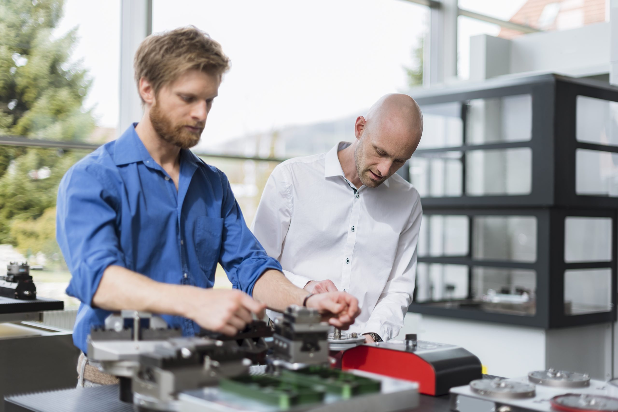 Two men working on product in company